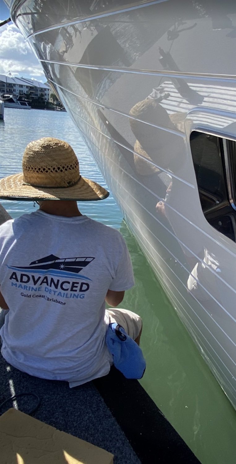 Detailing topsides at a marina berth