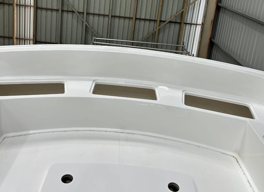 The same foredeck after correction, the gelcoat brought back to a clean and even gloss