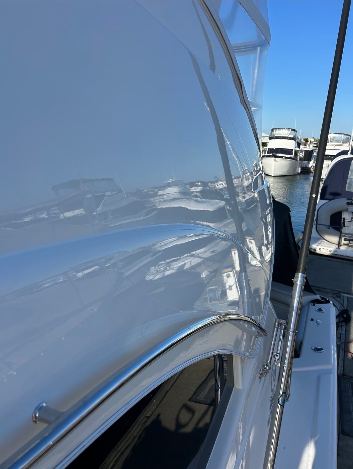 The same topsides after correction, now mirroring the marina and the boats opposite